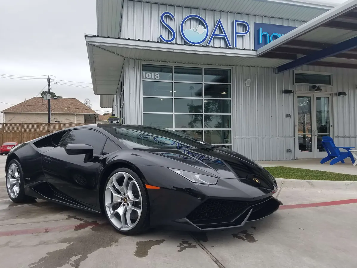 Black Lamborghini Huracan parked in front of SOAP Hand Car Wash