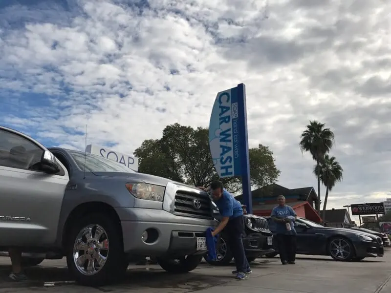 Crew hand washing a gray Toyota Tundra at SOAP Hand Car Wash