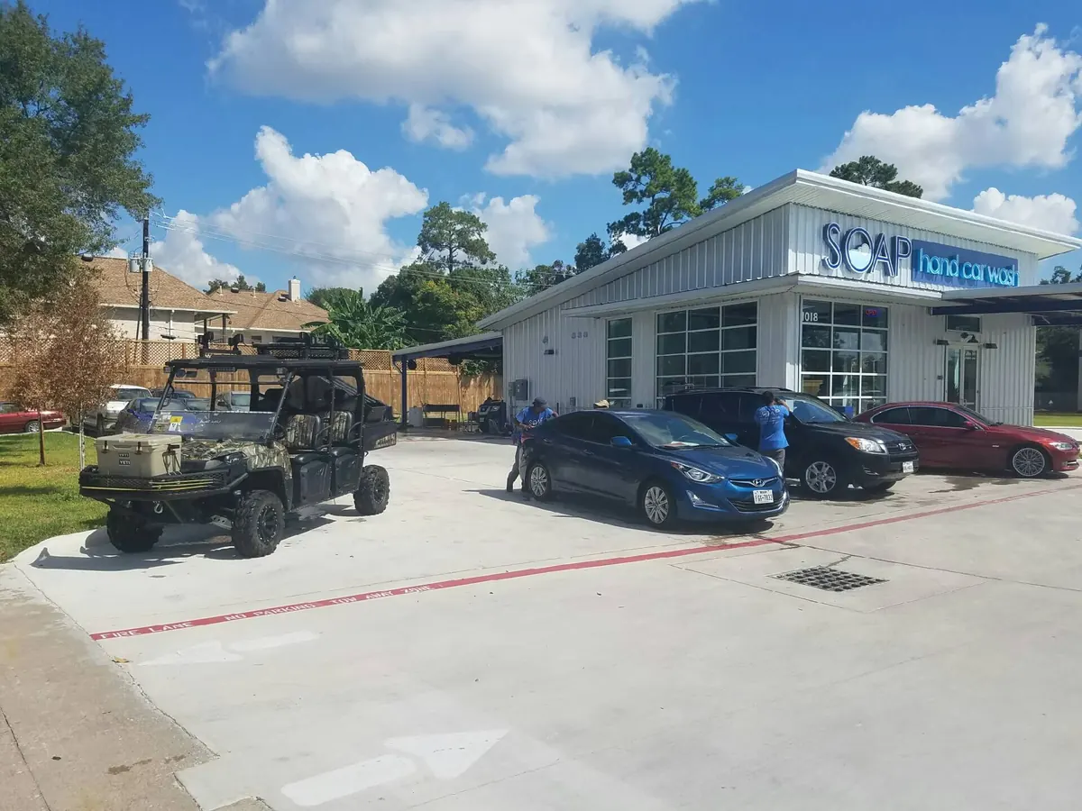Side-by-side UTV and cars being washed at SOAP Hand Car Wash