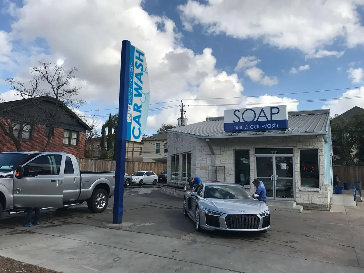 Silver Audi R8 and a pickup truck being washed at SOAP