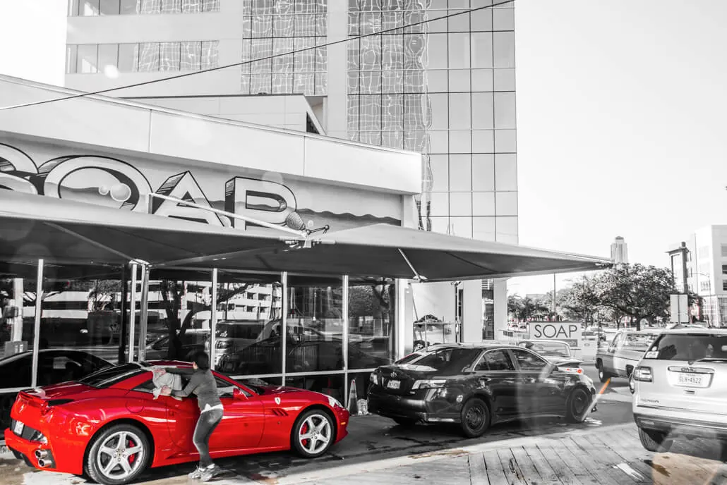 Red Ferrari at SOAP Hand Car Wash in a black and white photo