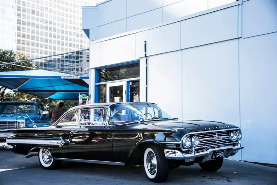 Classic black Chevrolet Impala parked outside a SOAP location