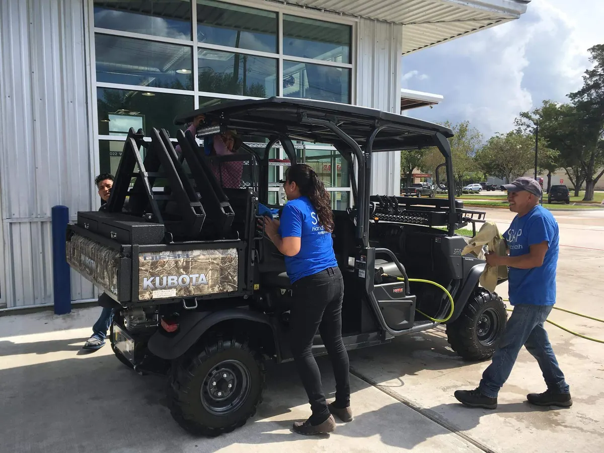 SOAP crew washing a Kubota utility vehicle